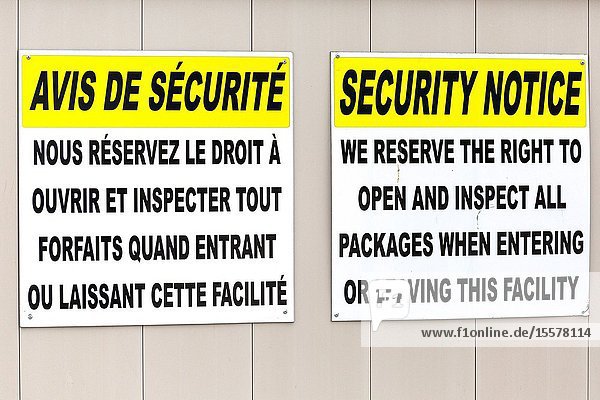 Corner Brook Newfoundland Canada. Security signs at port in French and English.