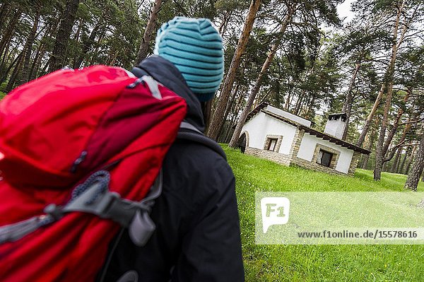 Young hiker walking towards mountain refuge in Iberian Mountain Range (Guadalajara province Castilla-La Mancha Region Spain)