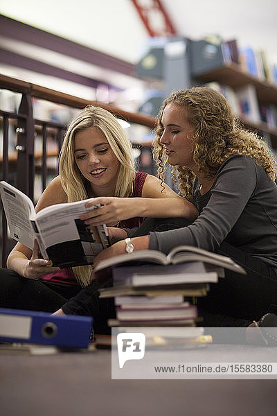 Two female students learning in a library