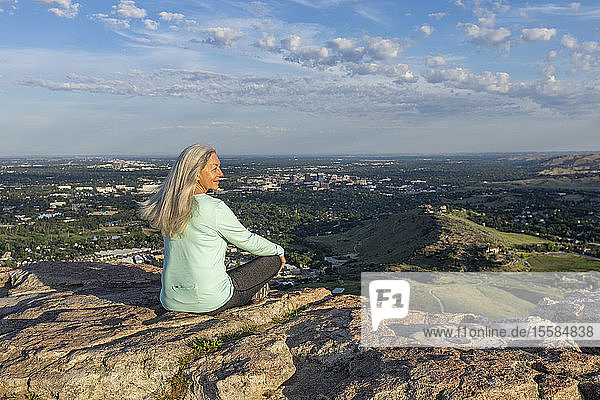 Mature woman sitting on rocks in Boise  Idaho  USA