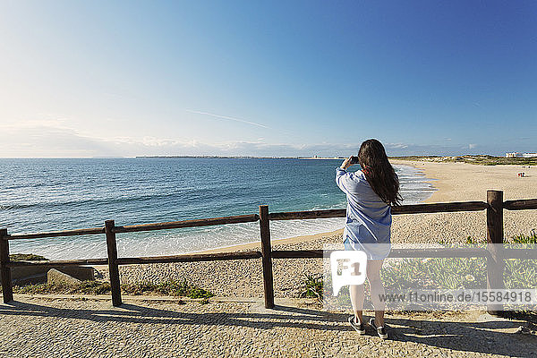Frau fotografiert Strand in Lissabon  Portugal