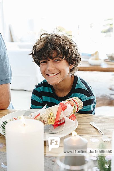 Boy smiling at dining table in home party