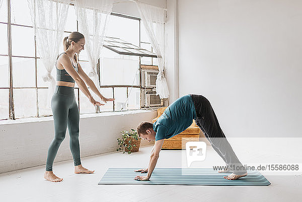 Yoga instructor teaching yoga in studio