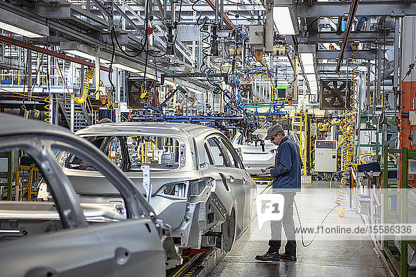 Workers on car production line in car factory