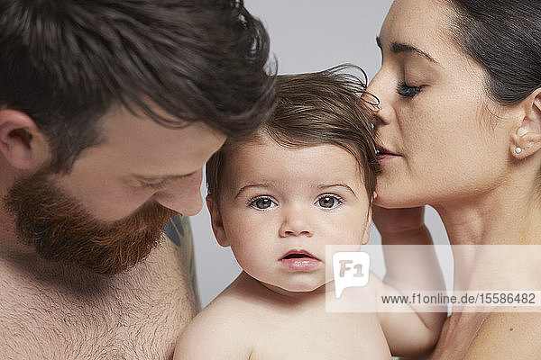 Portrait of couple and baby girl