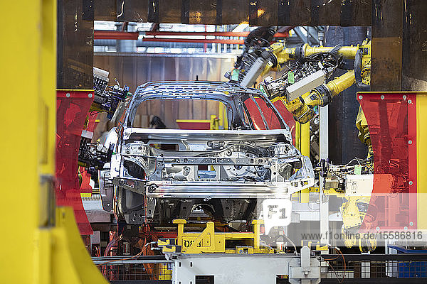 Robot laser welders with car body in car factory