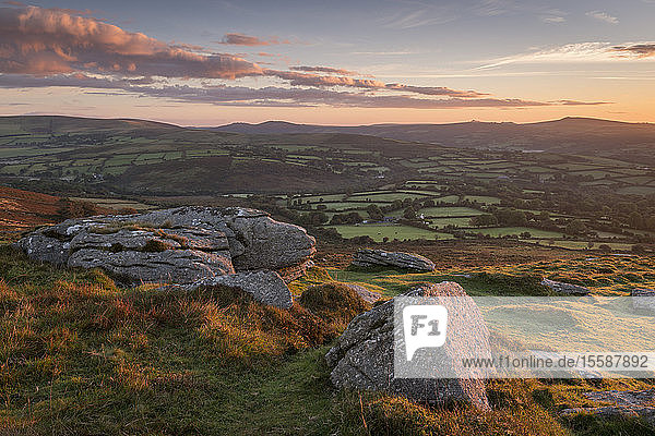 Sunrise over rolling countryside from Corndon Tor Dartmoor Devon England United Kingdom