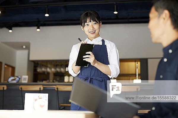 Young Japanese woman working at a restaurant