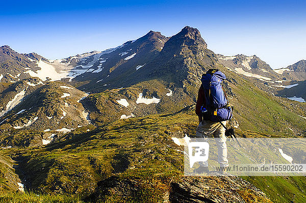A Man Backpacking Near Hatcher Pass In The Talkeetna Mountains  Southcentral  Alaska
