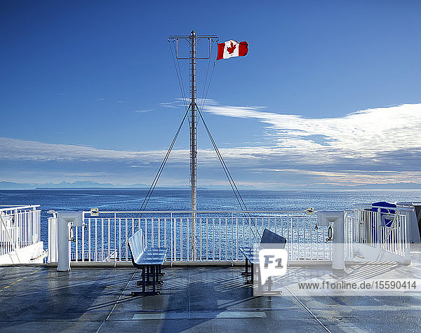 Deck of the new BC Ferry with a Canadian Flag going to Mayne Island; British Columbia Canada