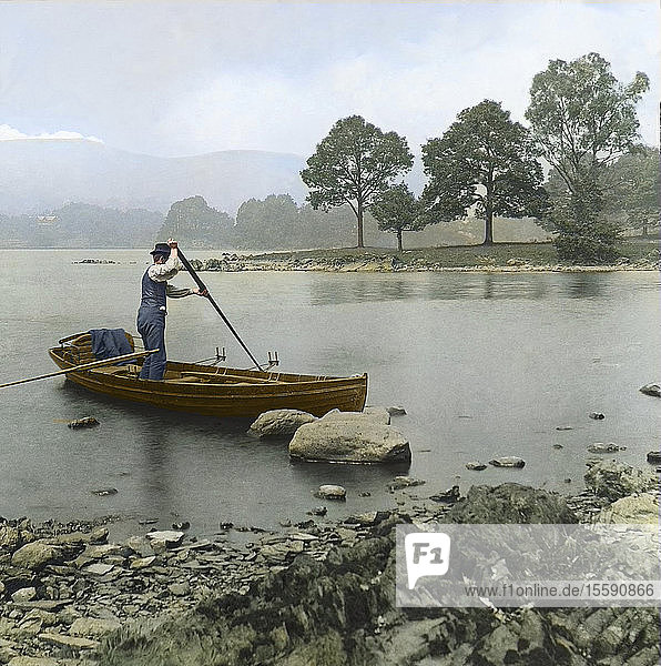 Magic Lantern slide circa 1880  Victorian/Edwardian  social history. A man punting a rowing boat on Lake Windermere; Cumbria  England