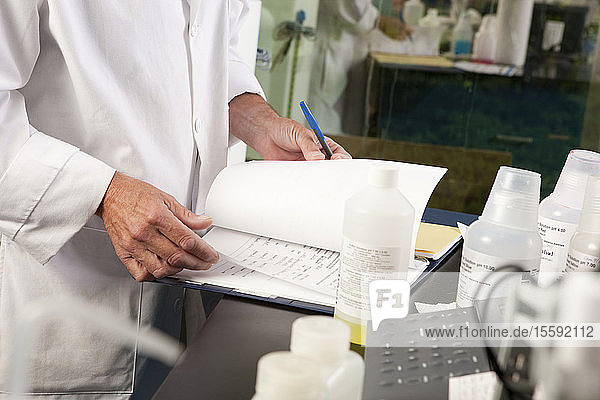 Scientist preparing a report in the laboratory of water treatment plant