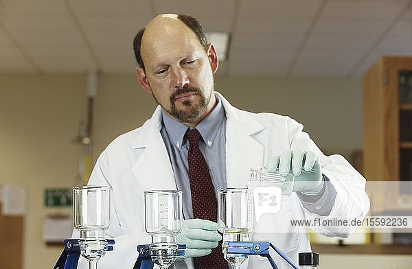 Scientist filtering a sample