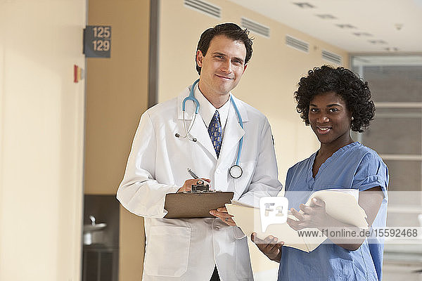 Doctor standing with a Jamaican female nurse