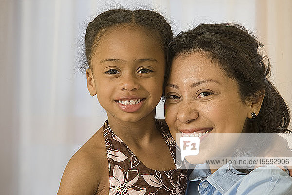 Hispanic woman smiling with her daughter