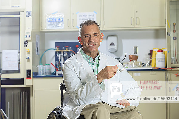 Portrait of a smiling professor with a spinal cord injury in a wheelchair