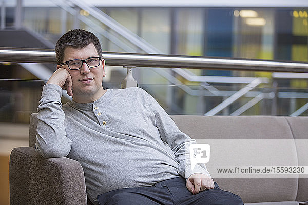 Man with Visual Impairment sitting on sofa at school