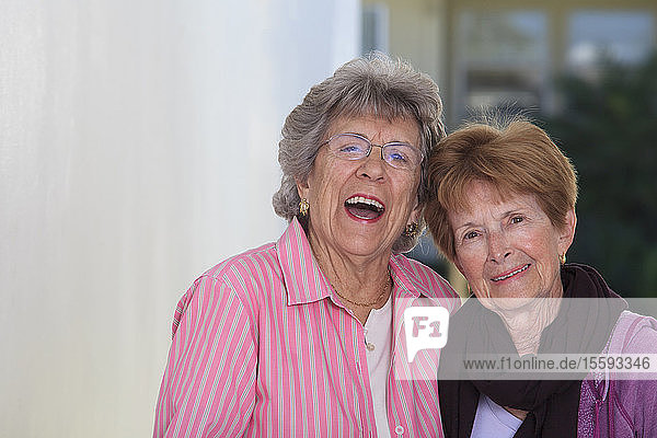 Two senior female friends smiling