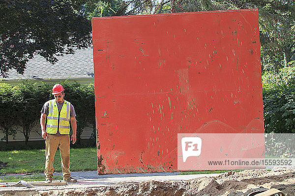 Construction worker standing beside shoring