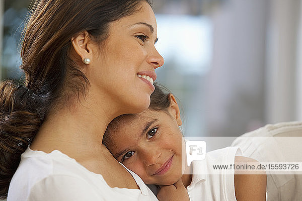 Hispanic woman hugging her daughter