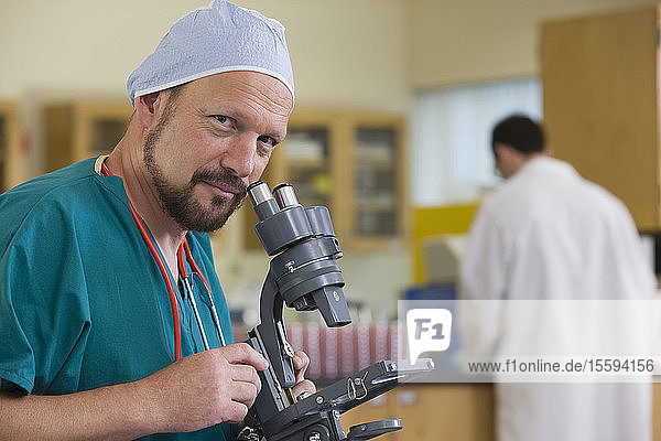 Scientist with a microscope in a laboratory
