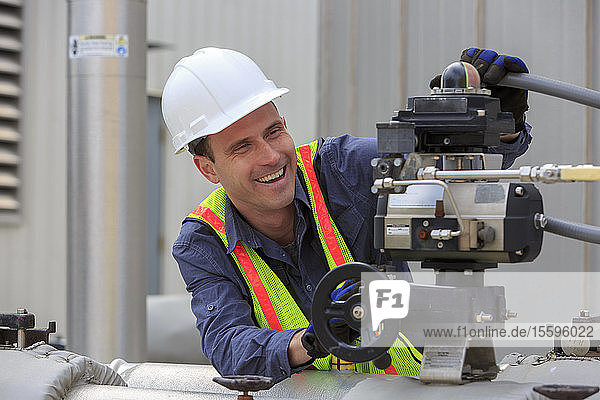 Industrial engineer working on a hydraulic pump at a power plant