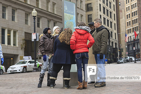 Tourists looking at a street map in Government Center  Boston  Suffolk County  Massachusetts  USA
