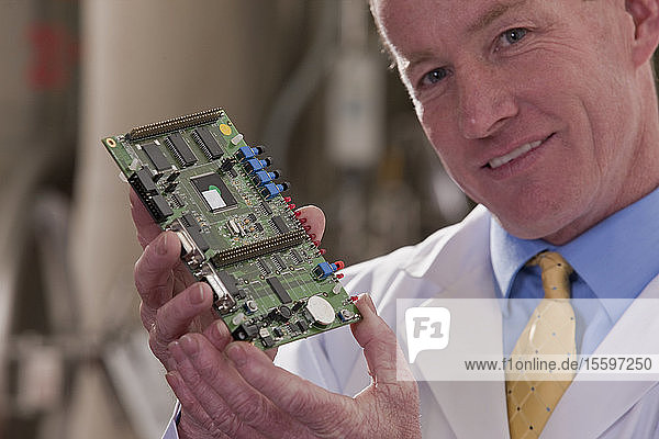 Engineer showing a micro controller circuit board