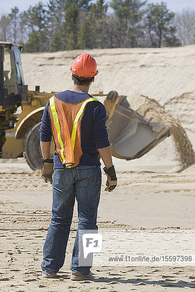 Engineer standing at a gravel and asphalt plant