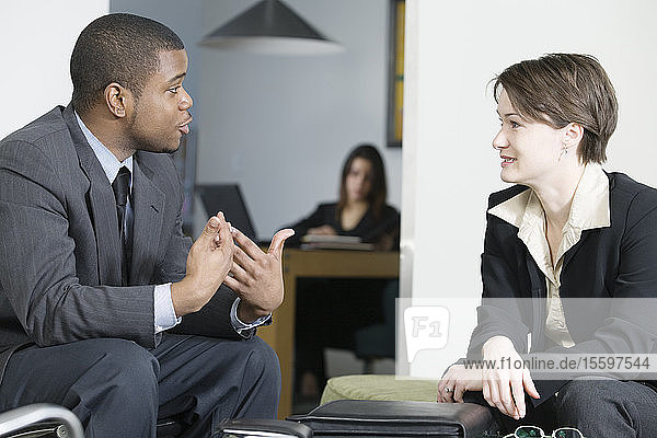 Business colleagues conversing in an office.