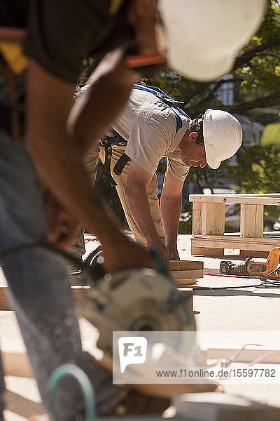 Carpenters using circular saw at a construction site