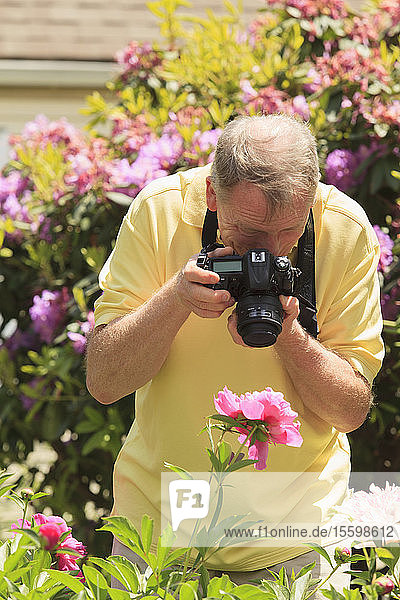 Man with Cerebral Palsy and dyslexia photographing his flowers