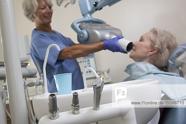 Female dentist taking X-Ray of her patient