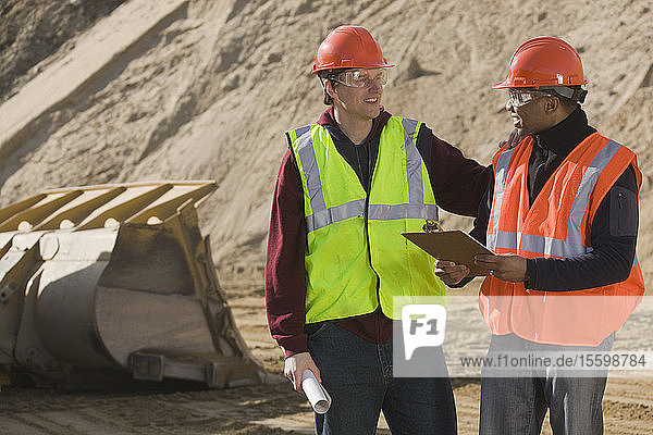 Two engineers discussing at a construction site
