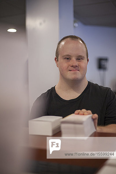 Portrait of waiter with Down Syndrome working in a restaurant