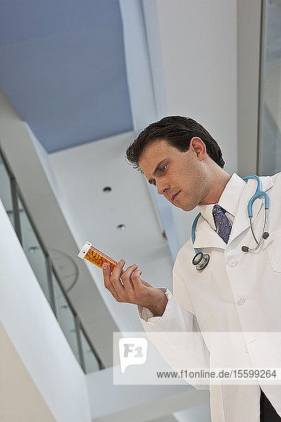 Doctor checking a pill bottle