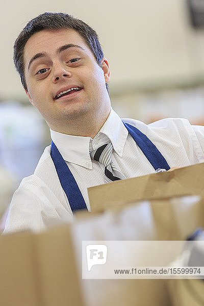 Man with Down Syndrome working at a grocery store