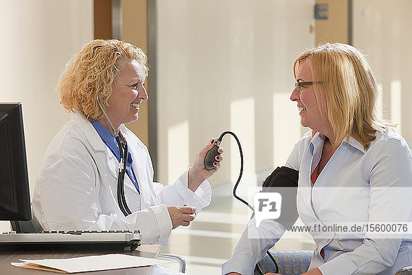 Female doctor measuring a patient's blood pressure