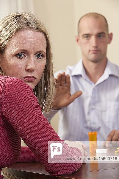 Man signing the word 'Yours' in American Sign Language while communicating with a woman
