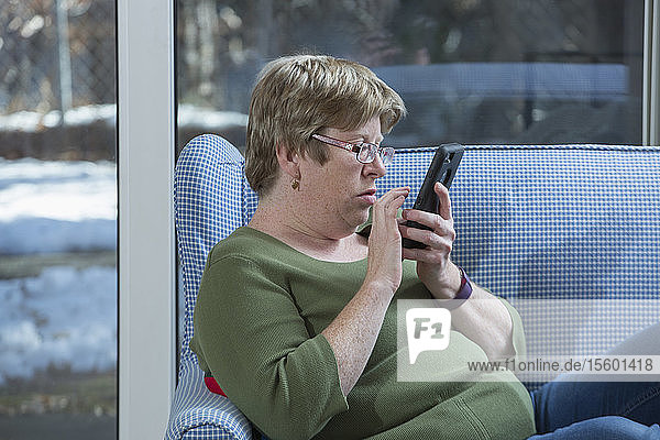 Woman with Autism using a smartphone
