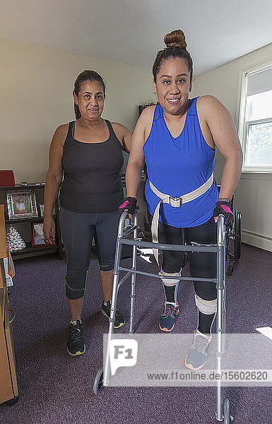 Woman with spinal cord injury getting up into her walker