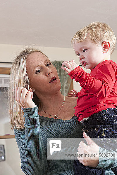 Woman signing the word 'Milk' in American Sign Language while communicating with her son