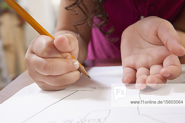 Close-up of a Hispanic girl drawing pictures
