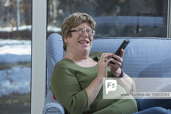 Frau mit Autismus benutzt ein Smartphone