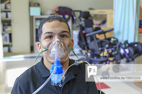 Boy with Spastic Quadriplegic Cerebral Palsy learning at school and using his medical breathing mask