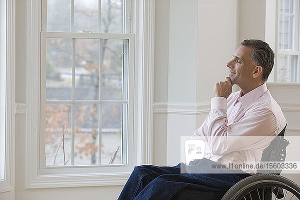Businessman day dreaming on a wheelchair
