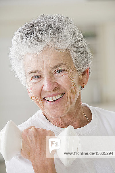 Portrait of a senior woman exercising with a hand weight