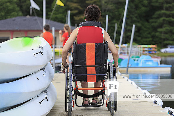 Woman with a Spinal Cord Injury in a wheelchair on a boat dock
