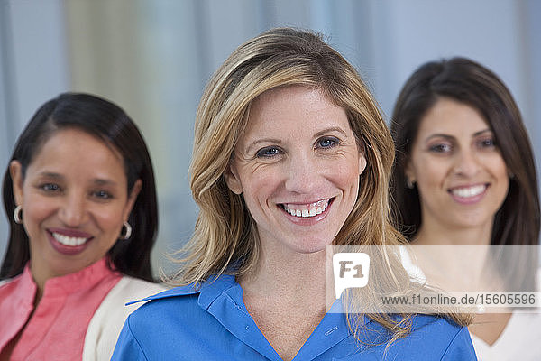 Portrait of a woman smiling with her friends in the background