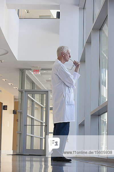 Doctor lost in thoughts at hospital window